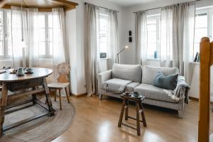 a living room with a couch and a table at Appartement no8 in Sankt Gilgen +36 photos