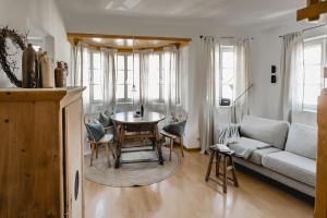 a living room with a table and a couch at Appartement no8 in Sankt Gilgen