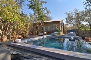 a swimming pool in the backyard of a house at Shiringa kruger lodge in Marloth Park