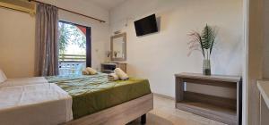 A bed or beds in a room at Alex Studios