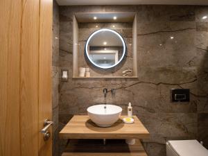 a bathroom with a bowl sink and a mirror at Hardriggs Bank Cottage in Kendal