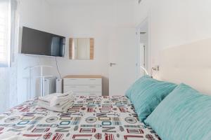 a bedroom with a bed with a tv on the wall at RentitSpain Castell Playa, vistas y parking in Castell de Ferro +64 photos