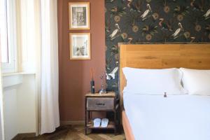 a bedroom with a bed and a night stand next to a bed sidx sidx sidx at Porta Tosa Boutique in Milan +42 photos