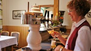 a woman is pouring a glass of wine at Landhaus Dahse in Karstädt