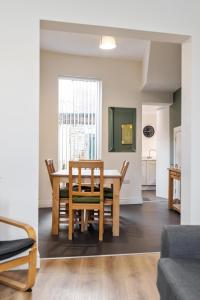 a dining room with a table and chairs at Clondara Terrace Belfast in Belfast +18 photos