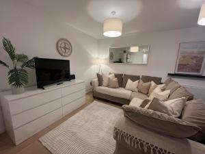 a living room with a couch and a flat screen tv at Spacious 2 Bed, 2 Bath Apartment by MCF in Horley