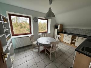 a kitchen with a table and chairs in a room at Haus Otto in Großhansdorf