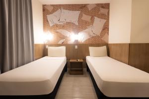 Postel nebo postele na pokoji v ubytování Hotel Cassino Tower Piracicaba by Nacional Inn
