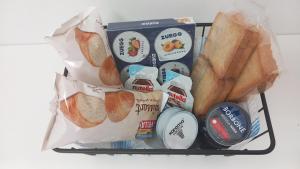a basket of food with bread and snacks at B&B dalla Nonna in Salerno