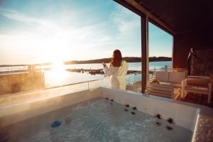 a woman standing in a hot tub on a boat at Panorama Rorbusuiter in Steinsland