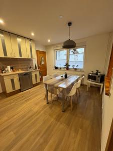 a kitchen and dining room with a table and chairs at Familienurlaub in Niederdorla - Heimatgefühl in Oberdorla +21 photos