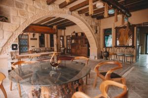 a dining room with a glass table and chairs at Karis Cave Cappadocia in Ürgüp
