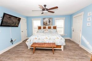 a bedroom with a bed and a ceiling fan at Oceanside, Wild Horses, Private Pool, Hot Tub -4x1941, A Sense of Porpoise in Knotts Island +28 photos