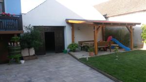a backyard with a playground with a wooden pergola at Gästehaus Schneider in Illmitz