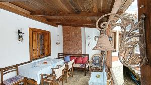 a dining room with a table and chairs in a room at Woodman’s home in Vlatanéoi