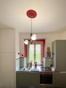 a kitchen with a sink and a red ceiling at Casetta Roma San Giovanni in Rome