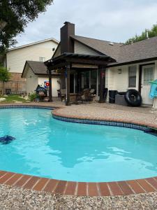a swimming pool in front of a house at The Ultimate Staycation in San Antonio