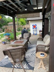 a patio with wicker furniture and a table and chairs at The Ultimate Staycation in San Antonio