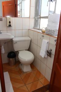 a bathroom with a toilet and a sink and a window at Don Andre House in Cusco +58 photos