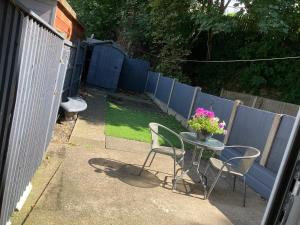 a patio with a table and chairs and a fence at 64 Carlton Street in Mansfield