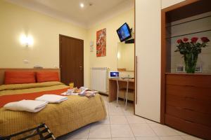 a hotel room with a bed and a television at Hotel Demo' in Milan