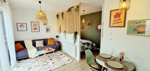 a living room with a couch and a table at Villa Cosy - Proche Bordeaux in Parempuyre