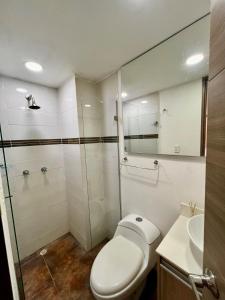 a bathroom with a toilet and a shower and a sink at Luxury 3BR Apartment in the heart of Medellin in Medellín +19 photos