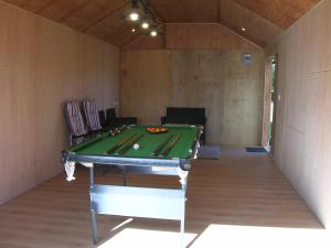 a ping pong table in a room with a ping pong table at Bevan House with Hot Tub in Mid-Wales in Hundred House