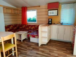 a living room with a couch and a table at Camping les Oliviers in Oraison