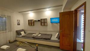 a bedroom with a bed and a tv on the wall at Holiday Apartman in Mórahalom +20 photos