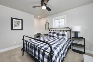 a bedroom with a bed and a ceiling fan at Toes in the Water , pool , perfect for large groups in South Haven