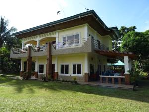 a house with a large lawn in front of it at Bregman Residance in Plaridel