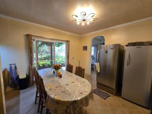 a dining room with a table and a refrigerator at Bregman Residance in Plaridel