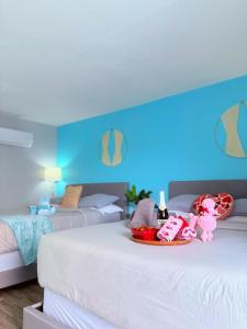 a bedroom with two beds with stuffed animals on the bed at 1915 Beach Club in Daytona Beach