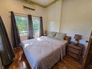 a bedroom with a bed and a large window at Bregman Residance in Plaridel +42 photos