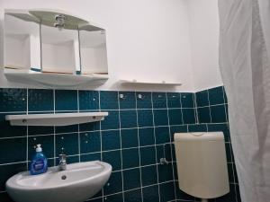 a bathroom with a white sink and a toilet at Feriengarten Dahme W 21 in Dahme +7 photos