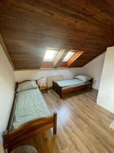 a bedroom with two beds and a ceiling with skylights at Varady's large apartment with private parking in Košice