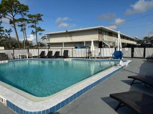 a swimming pool with chairs in front of a building at Magic Key - Near Disney in Kissimmee