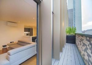 a living room with a couch and a table at Elysium by The Heim Residences in Manchester