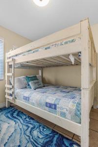 a bedroom with two bunk beds in a room at Sunrise Village 215- 2BR 1BA gulf front sleep 6 in Gulf Shores