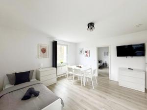 a bedroom with a bed and a table and a tv at Cozy & warm Apartment in Ennepetal in Ennepetal