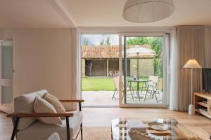 a living room with a couch and a table at The Old Barn in Sandwich