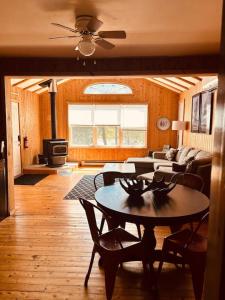 a living room with a table and a couch at Stella by Starlight in Tobermory