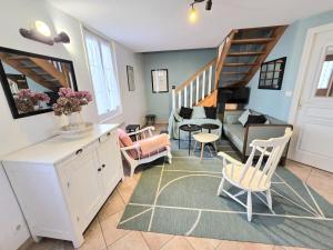 a living room with a staircase and a couch at Valmy in Brantôme