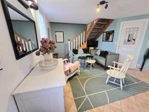 a living room with a couch and a table and chairs at Valmy in Brantôme