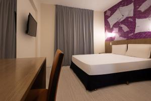 Postel nebo postele na pokoji v ubytování Hotel Cassino Tower Piracicaba by Nacional Inn