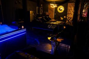 a living room with blue lights in a dark room at Appartement Romance et chic in Bevons