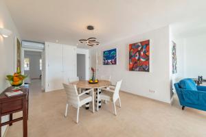 a dining room with a table and chairs at Windsong in Port de Pollensa