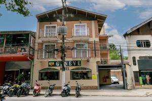 a group of motorcycles parked in front of a building at Hotel Geneve - 2km do Capivari in Campos do Jordão