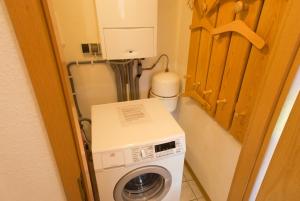 a washer and dryer in a small room at Ferienhaus Gruber in Norddeich +4 photos